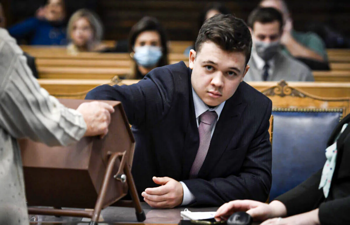 Kyle Rittenhouse pulls numbers of jurors out of a tumbler during his trail at the Kenosha County Courthouse in Kenosha, Wis., on Nov. 16, 2021. (Sean Krajacic/The Kenosha News via AP, Pool)