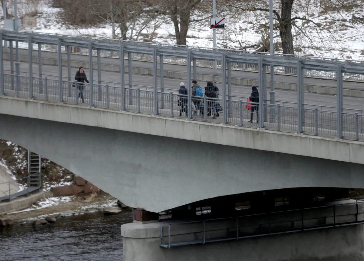 People walk on the bridge over the river Narva at the border crossing point with Russia in Narva, Estonia, on Feb. 16, 2017. (Ints Kalnins/Reuters)
