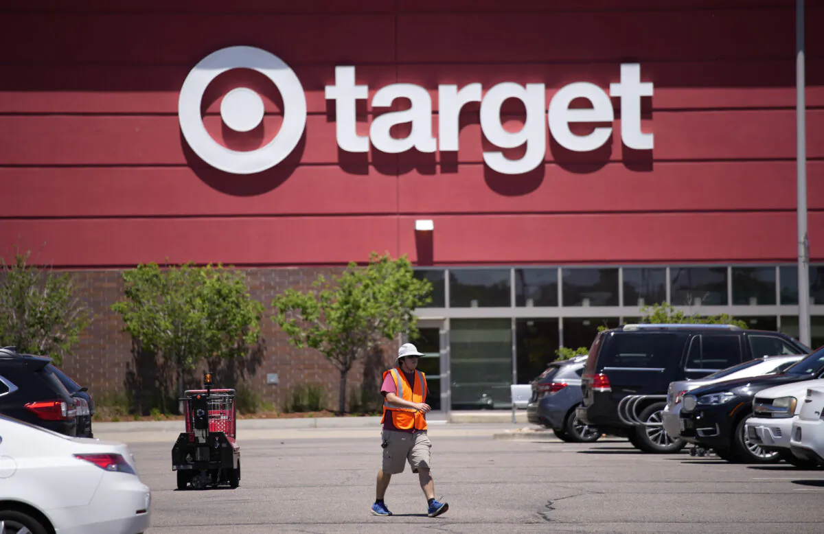 A worker collects shopping carts in the parking lot of a Target store in Highlands Ranch, Colo., on June 9, 2021. (David Zalubowski/AP Photo)