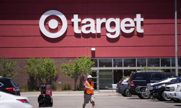 A worker collects shopping carts in the parking lot of a Target store in Highlands Ranch, Colo., on June 9, 2021. (David Zalubowski/AP Photo)