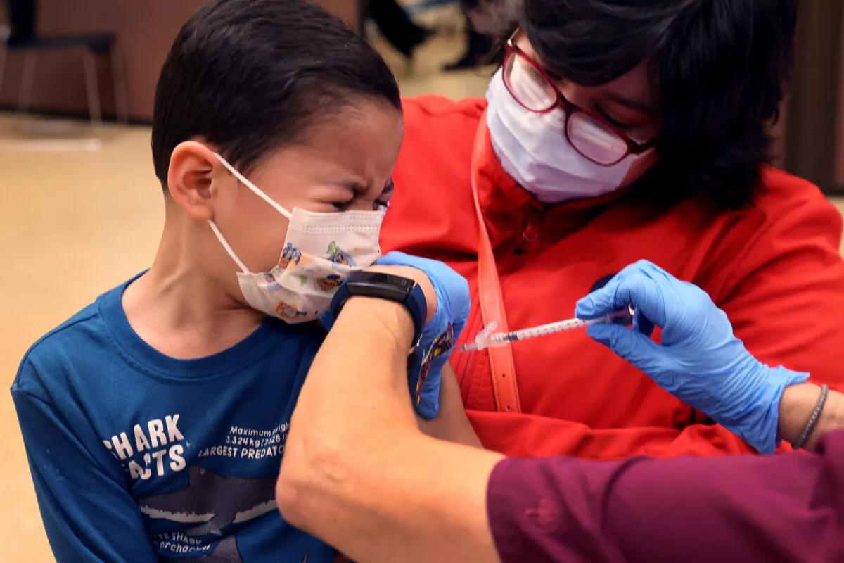 First grade student, 6-year-old Leonel Campos, receives a COVID-19 vaccine at Arturo Velasquez Institute on Nov. 12, 2021 in Chicago, Illinois. ( Scott Olson/Getty Images)