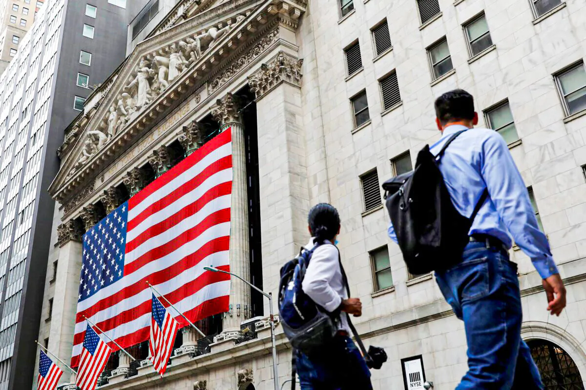 People walk by the New York Stock Exchange (NYSE) in Manhattan, New York City on Aug. 9, 2021. (Andrew Kelly/Reuters)
