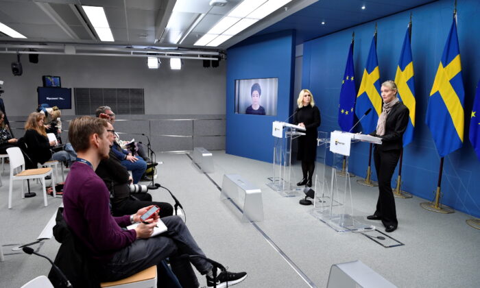 Minister for Culture and Democracy Amanda Lind (on screen), Minister for Health and Social Affairs Lena Hallengren, and Head of Sweden's Public Health Agency Karin Tegmark Wisell attend a press conference on new restrictions to curb the spread of the coronavirus disease, in Stockholm, on Nov. 17, 2021. (Jessica Gow/TT News Agency/via Reuters)