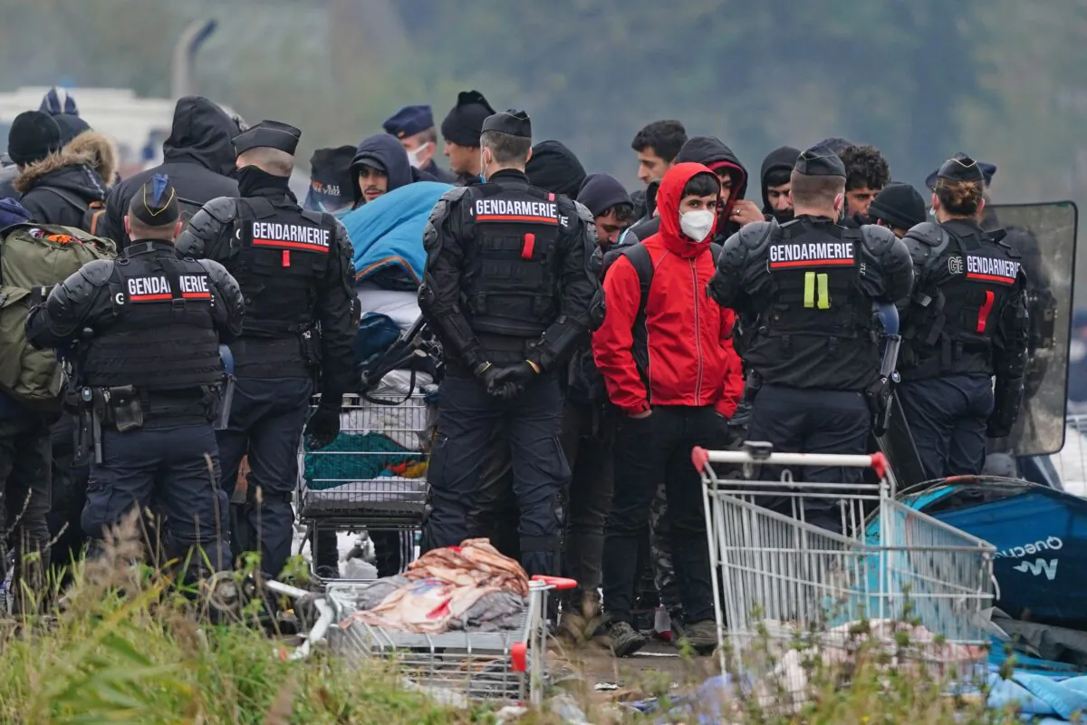 Migrants at a makeshift camp on the site of a former industrial complex east of Dunkirk, France, on Nov. 16, 2021. (PA)
