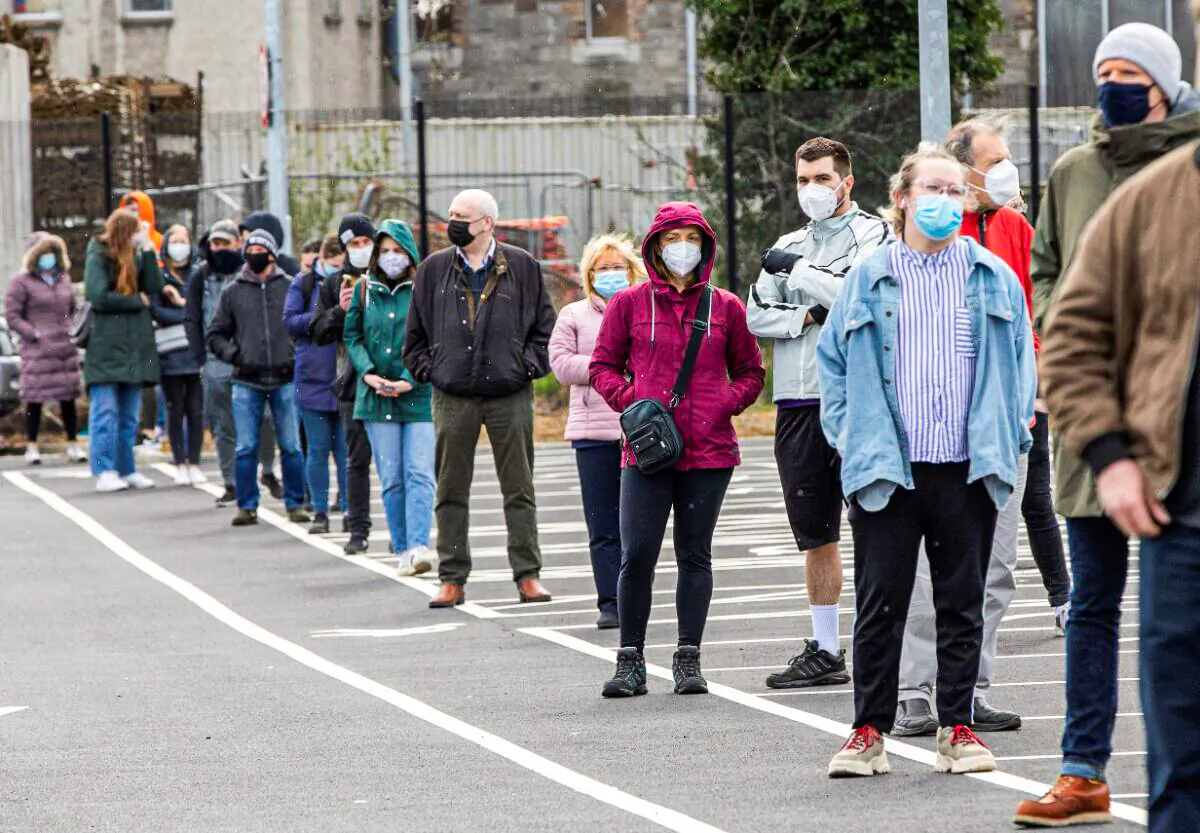 People wait in a line to receive a swab test for COVID-19 at a walk-in portable testing center operated by the ambulance service in Dublin, Ireland on March 25, 2021. (Paul Faith/AFP via Getty Images)
