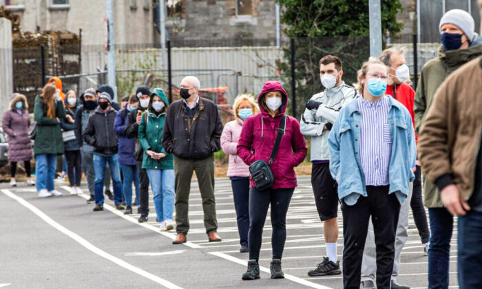 People wait in a line to receive a swab test for COVID-19 at a walk-in portable testing center operated by the ambulance service in Dublin, Ireland on March 25, 2021. (Paul Faith/AFP via Getty Images)