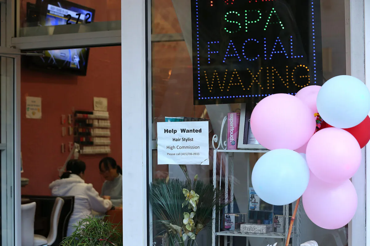 A help wanted sign hangs on the window of a nail salon in San Francisco on Dec. 7, 2012. (Justin Sullivan/Getty Images)