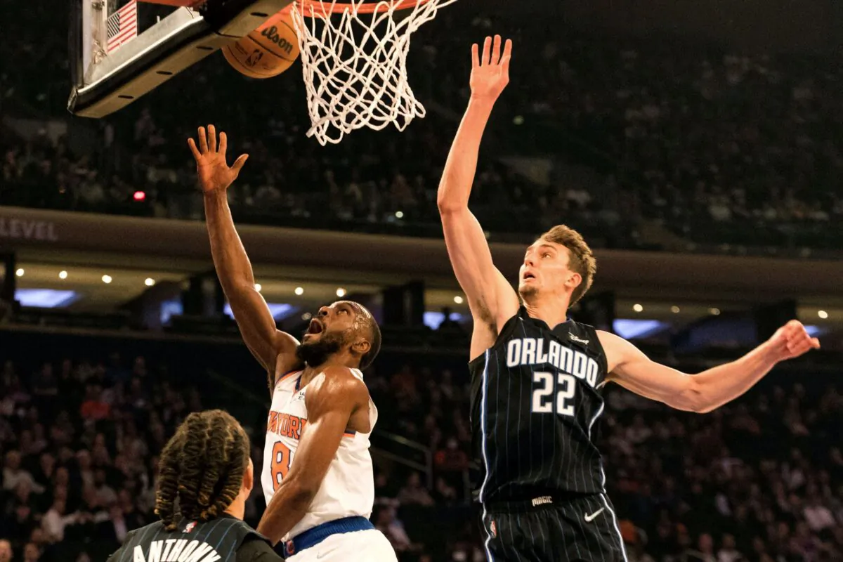 New York Knicks guard Kemba Walker (8) makes the basket against Orlando Magic's Franz Wagner during the first half of an NBA basketball game in New York, on Nov. 17, 2021. (Jessie Alcheh/AP Photo)