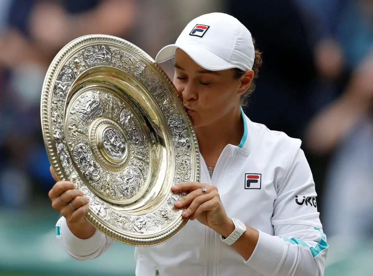 Australia's Ashleigh Barty poses with the trophy for the media after winning the women's singles final after defeating the Czech Republic's Karolina Pliskova on day twelve of the Wimbledon Tennis Championships in London, on July 10, 2021. (Pete Nichols/Pool via AP)