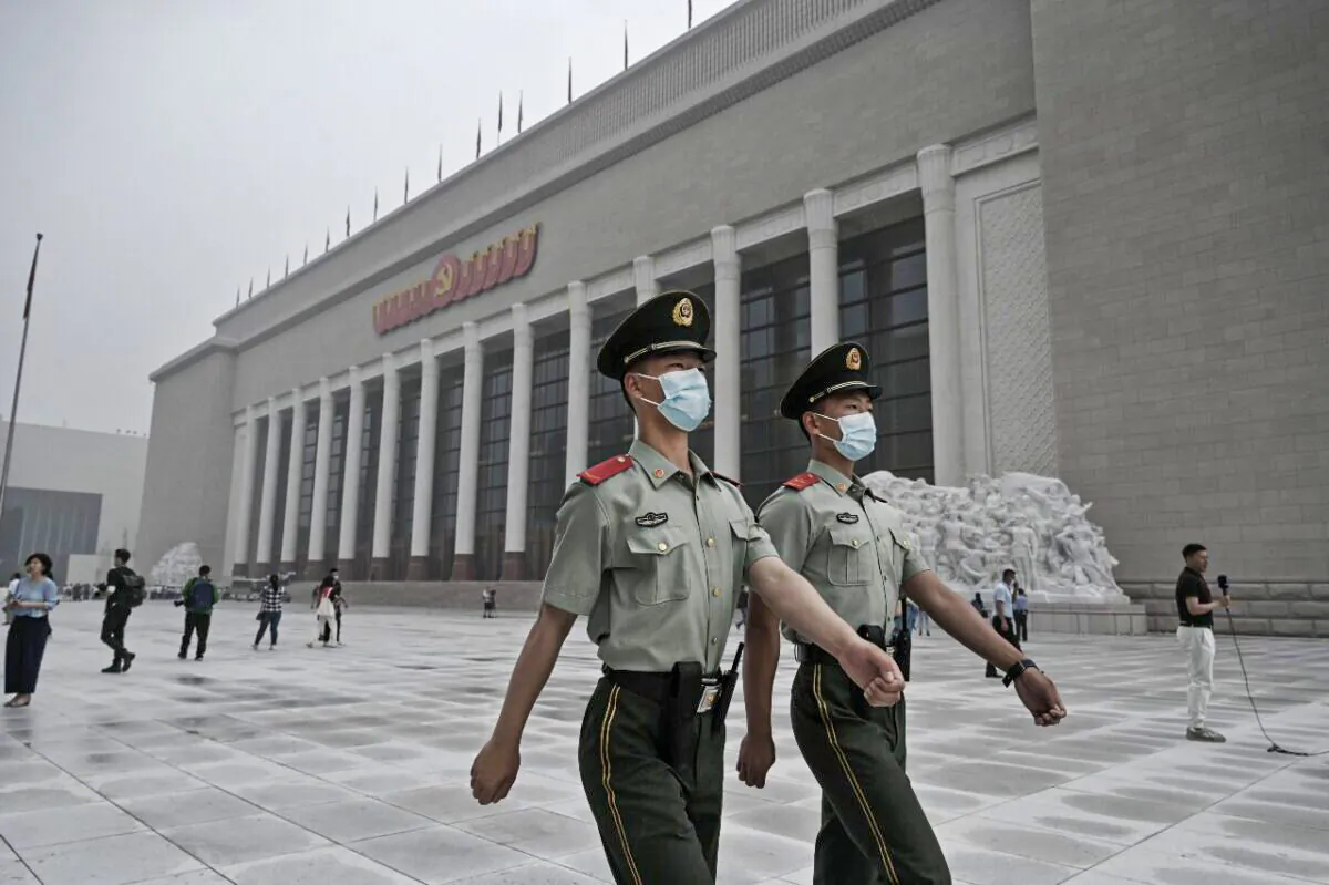 Chinese police officers walk outside the newly built Museum of the Chinese Communist Party in Beijing, China, on June 25, 2021. (Kevin Frayer/Getty Images)