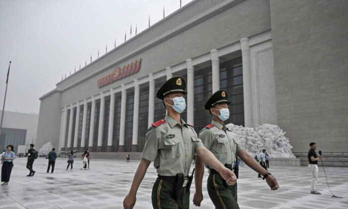 Chinese police officers walk outside the newly built Museum of the Chinese Communist Party in Beijing, China, on June 25, 2021. (Kevin Frayer/Getty Images)