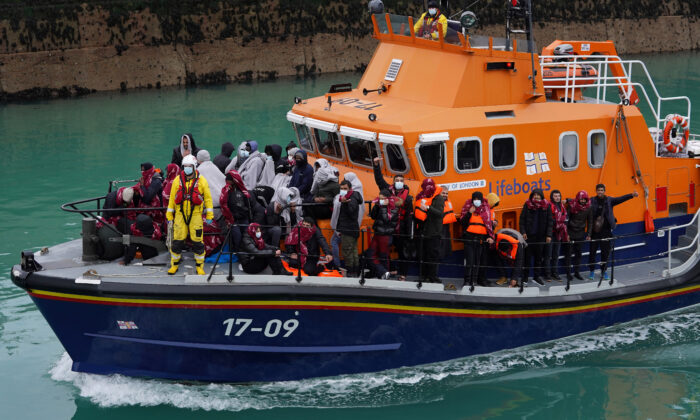 A group of people on board the Dover lifeboat following a small boat incident in the English Channel are brought in to Dover, Kent, England, on Nov. 11, 2021. (Gareth Fuller/PA)
