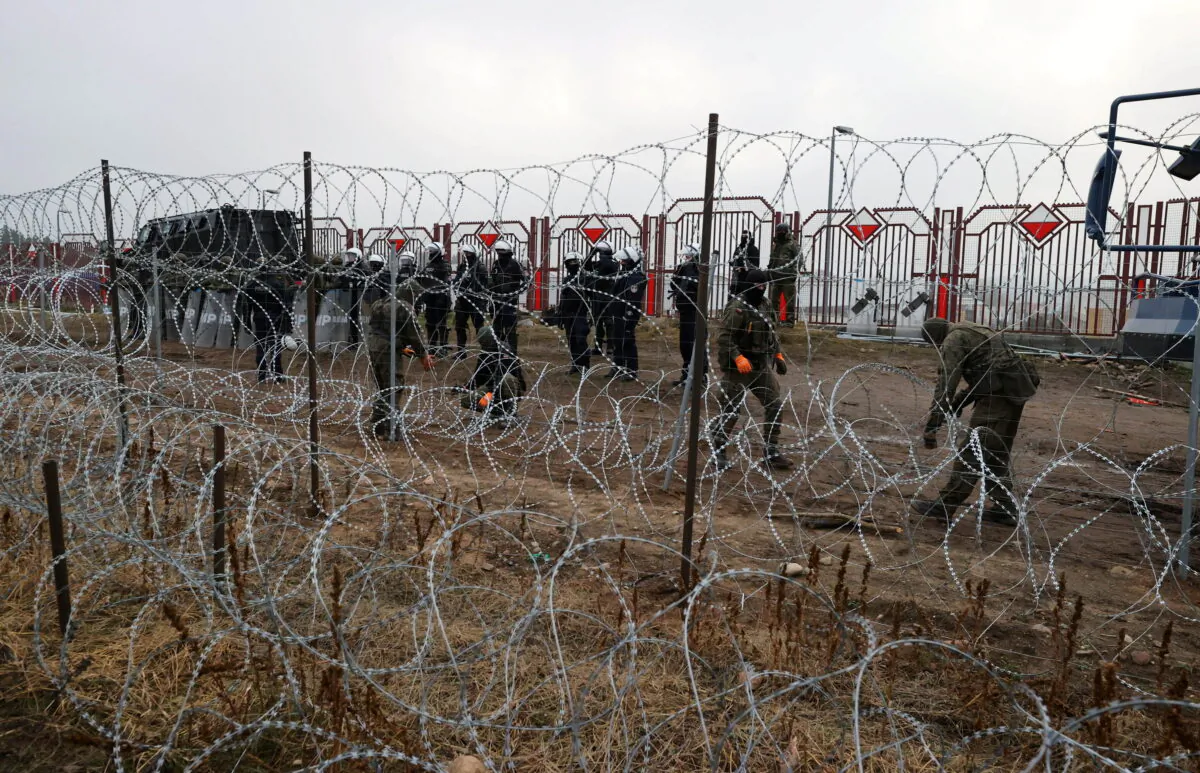 Migrants from the Middle East and elsewhere gather at the Belarus-Poland border near Grodno, Belarus, on Nov. 8, 2021. (Leonid Shcheglov/BelTA via AP)