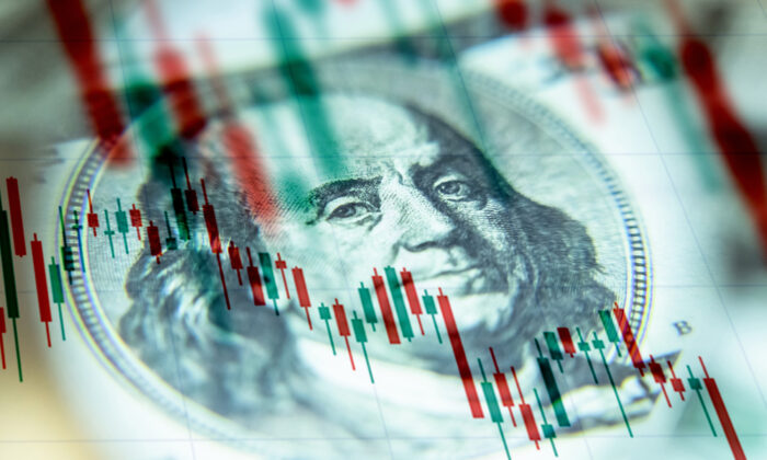 The U.S. dollar against the background of a declining chart. (Shutterstock)