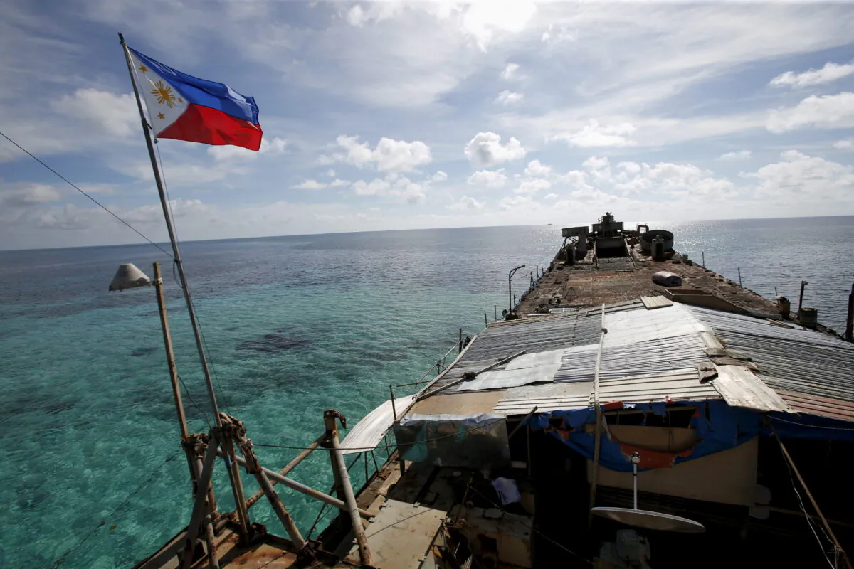 A Philippine flag flutters from BRP Sierra Madre, a dilapidated Philippine Navy ship that has been around since 1999 and became a Philippine military detachment on the disputed Second Thomas Shoal, part of the Spratly Islands, in the South China Sea on March 29, 2014. (Erik De Castro/Reuters)