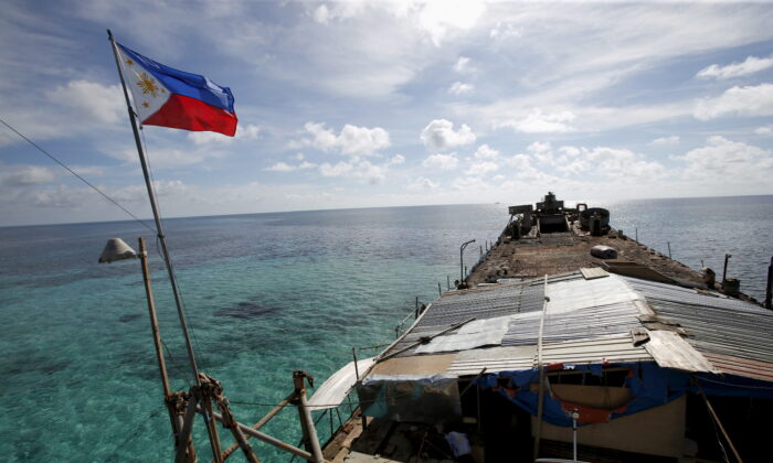 A Philippine flag flutters from BRP Sierra Madre, a dilapidated Philippine Navy ship that has been aground since 1999 and became a Philippine military detachment on the disputed Second Thomas Shoal, part of the Spratly Islands, in the South China Sea March 29, 2014. (Erik De Castro/Reuters)