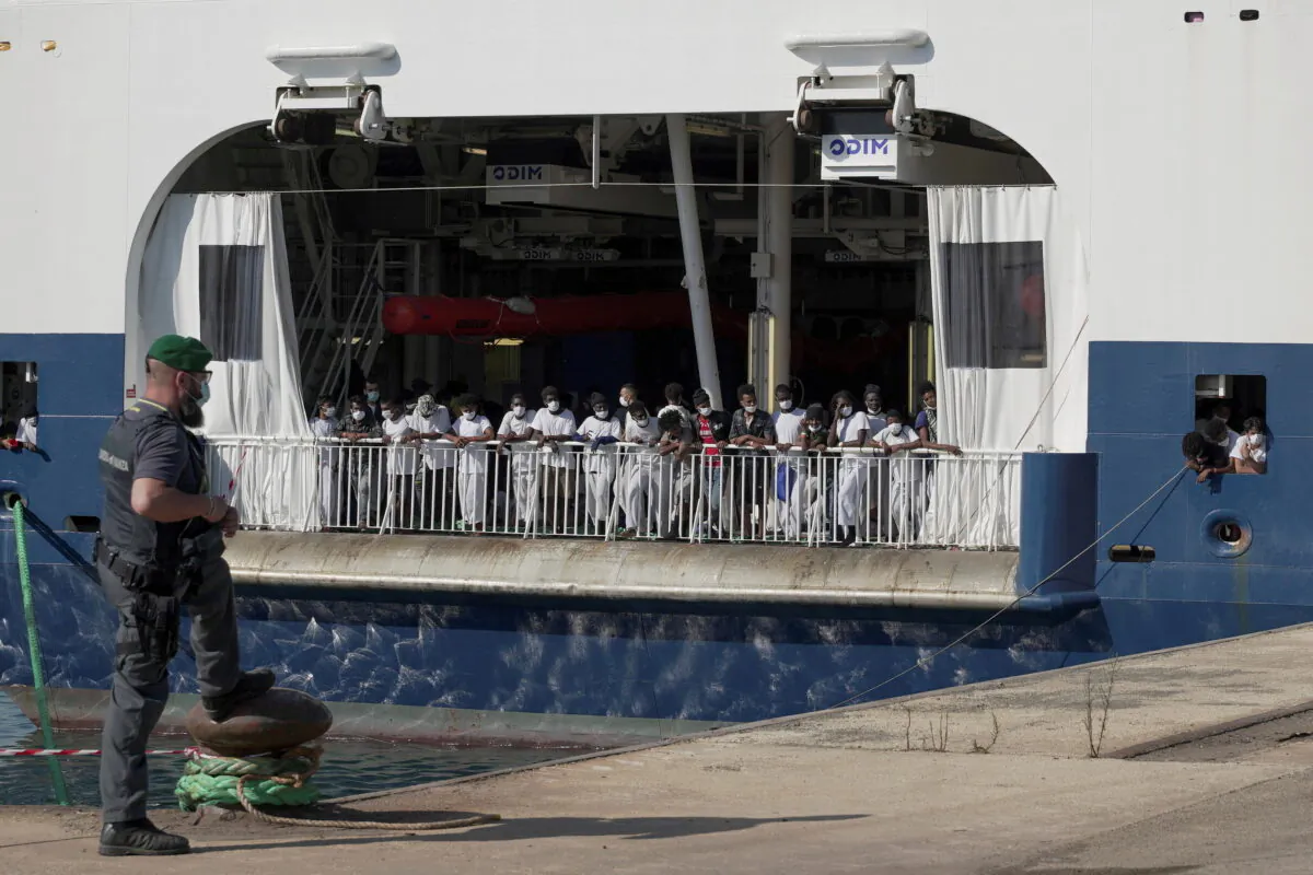 Migrants wait to disembark the ship 'Geo Barents' run by Doctors Without Borders (MSF) as it is given permission to dock at the Sicilian port of Augusta after a week of waiting at sea, in Augusta, Italy, on June 18, 2021. (Antonio Parrinello/Reuters)