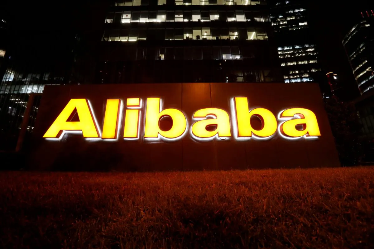 The logo of Alibaba Group is lit up at its office building in Beijing, China, on Aug. 9, 2021. (Tingshu Wang/Reuters)