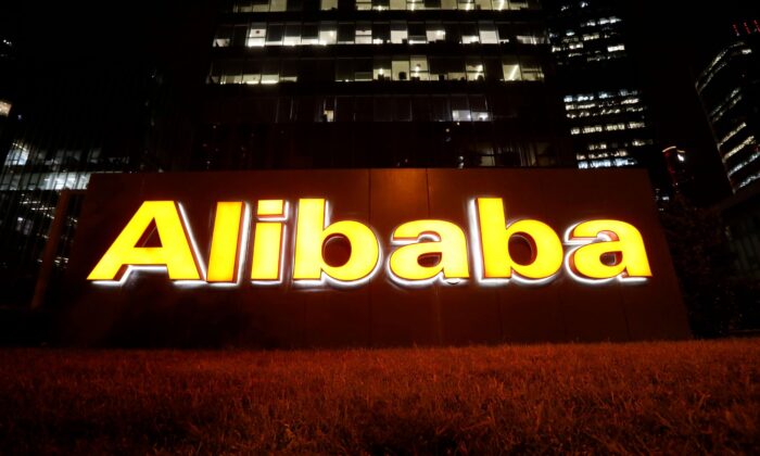 The logo of Alibaba Group is lit up at its office building in Beijing, China, on Aug. 9, 2021. (Tingshu Wang/Reuters)