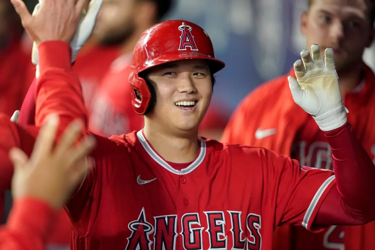 Los Angeles Angels' Shohei Ohtani is greeted in the dugout after he hit a solo home run during the first inning of a baseball game against the Seattle Mariners in Seattle, on Oct. 3, 2021. (Ted S. Warren/AP Photo)