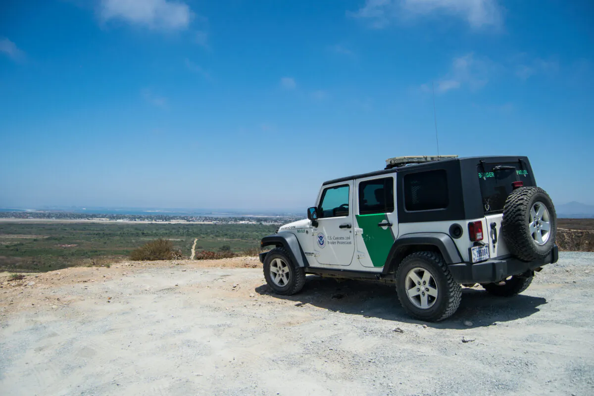A Border Patrol jeep overlooks the end of the U.S.-Mexico border barrier at the Pacific Ocean in San Diego. (Joshua Philipp/The Epoch Times)