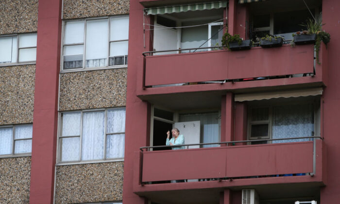 A resident stands on a balcony of a public housing apartment in Redfern in Sydney, Australia, on Sept. 16, 2021. (Lisa Maree Williams/Getty Images)