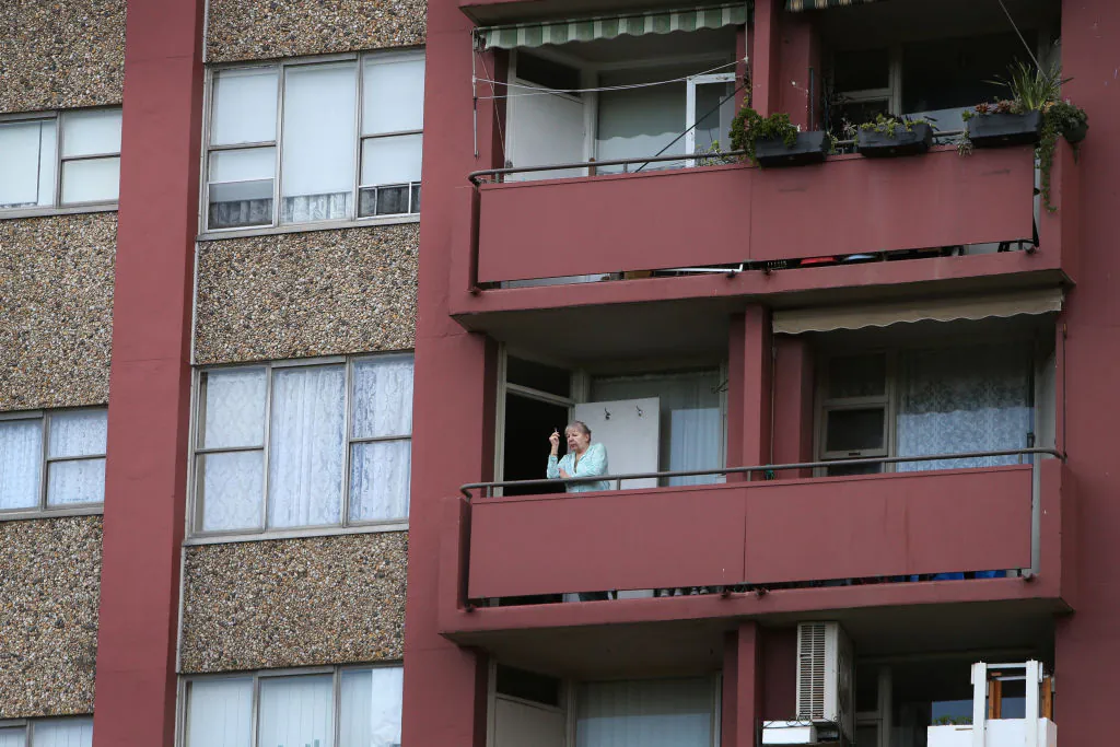 A resident stands on a balcony of a public housing apartment in Redfern in Sydney, Australia, on Sept. 16, 2021. (Lisa Maree Williams/Getty Images)