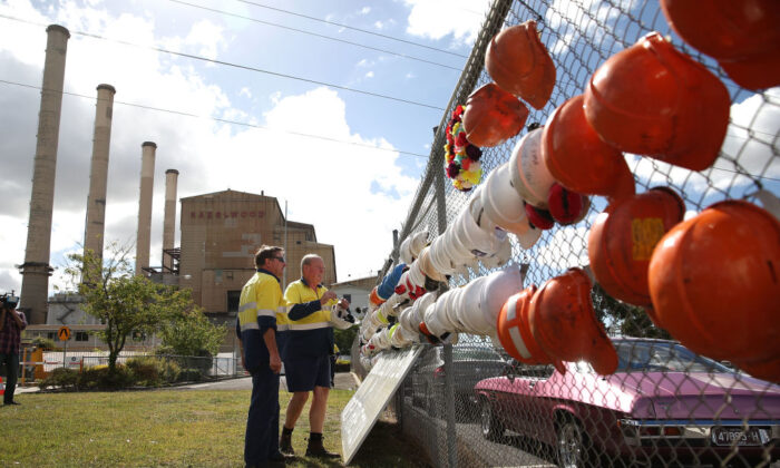 Workers hang their hard hats on the fence outside of the Hazelwood Power Station on the final day of operation in Hazelwood, Australia, on March 31, 2017. (Scott Barbour/Getty Images)
