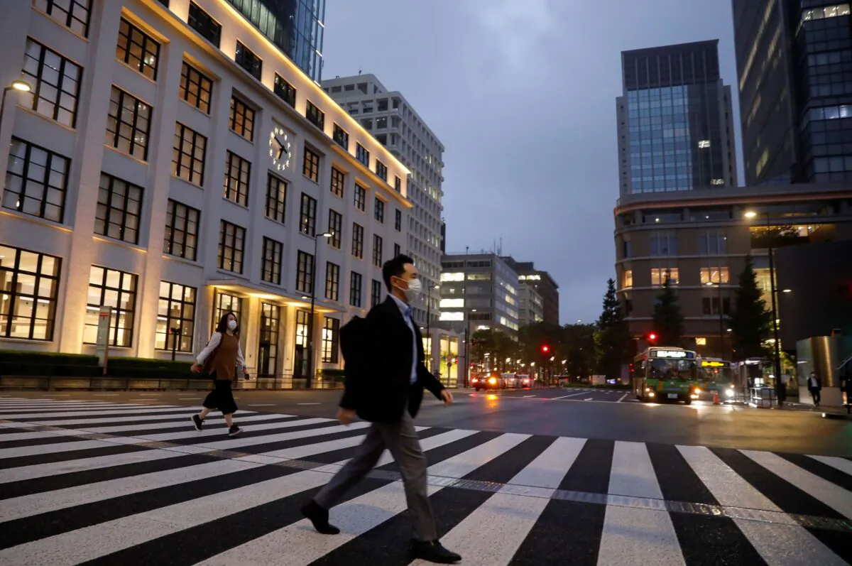 A pedestrian wearing a protective face mask crosses a street, amid the coronavirus disease (COVID-19) outbreak, in the business district in Tokyo, Japan, on May 21, 2020. (Kim Kyung-Hoon/Reuters)