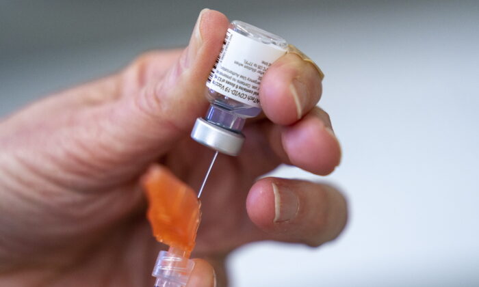 A syringe is loaded with the Pfizer COVID-19 vaccine in British Columbia, Canada on April 10, 2021. (Jonathan Hayward/The Canadian Press via AP)