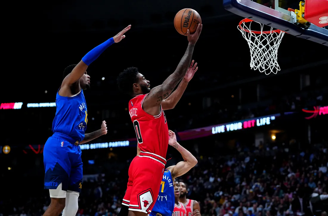 Chicago Bulls guard Coby White (0) shoots the ball past Denver Nuggets guard Monte Morris (11) in the second quarter at Ball Arena in Denver, Colo., on Nov. 19, 2021. (Ron Chenoy/USA TODAY Sports via Field Level Media)