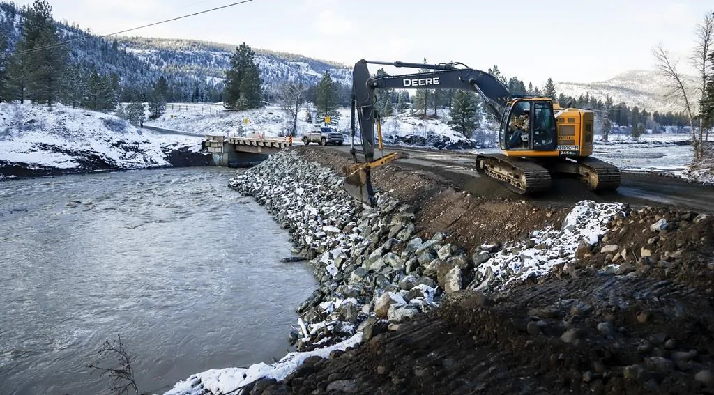 Construction crews work to build a bridge for the Nooaitch First Nation near Merritt, B.C., which has been completely cut off by flooding on, Nov. 19, 2021. (The Canadian Press/Jeff McIntosh)
