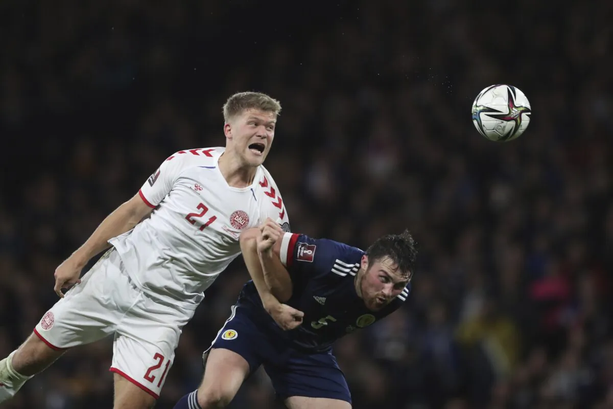 Denmark's Andreas Evald Cornelius (L) fights for the ball with Scotland's John Souttar during the World Cup 2022 group F qualifying soccer match between Scotland and Denmark at Hampden Park stadium in Glasgow, Scotland, on Nov. 15, 2021. (Scott Heppell/AP Photo)