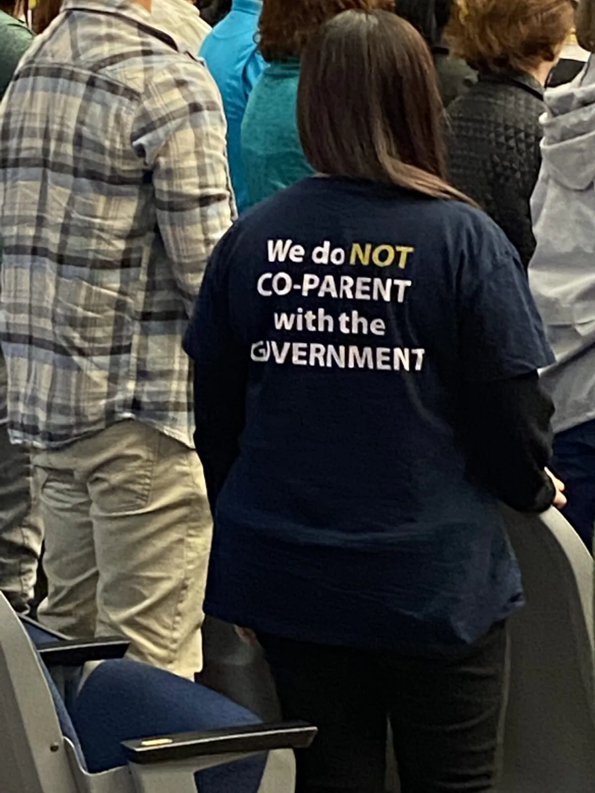 A Flagler County parent makes her feeling clear on the subject of who is in charge when it comes to the children as she observes proceedings at a Nov. 16, 2021, school board meeting. (Patricia Tolson/The Epoch Times)
