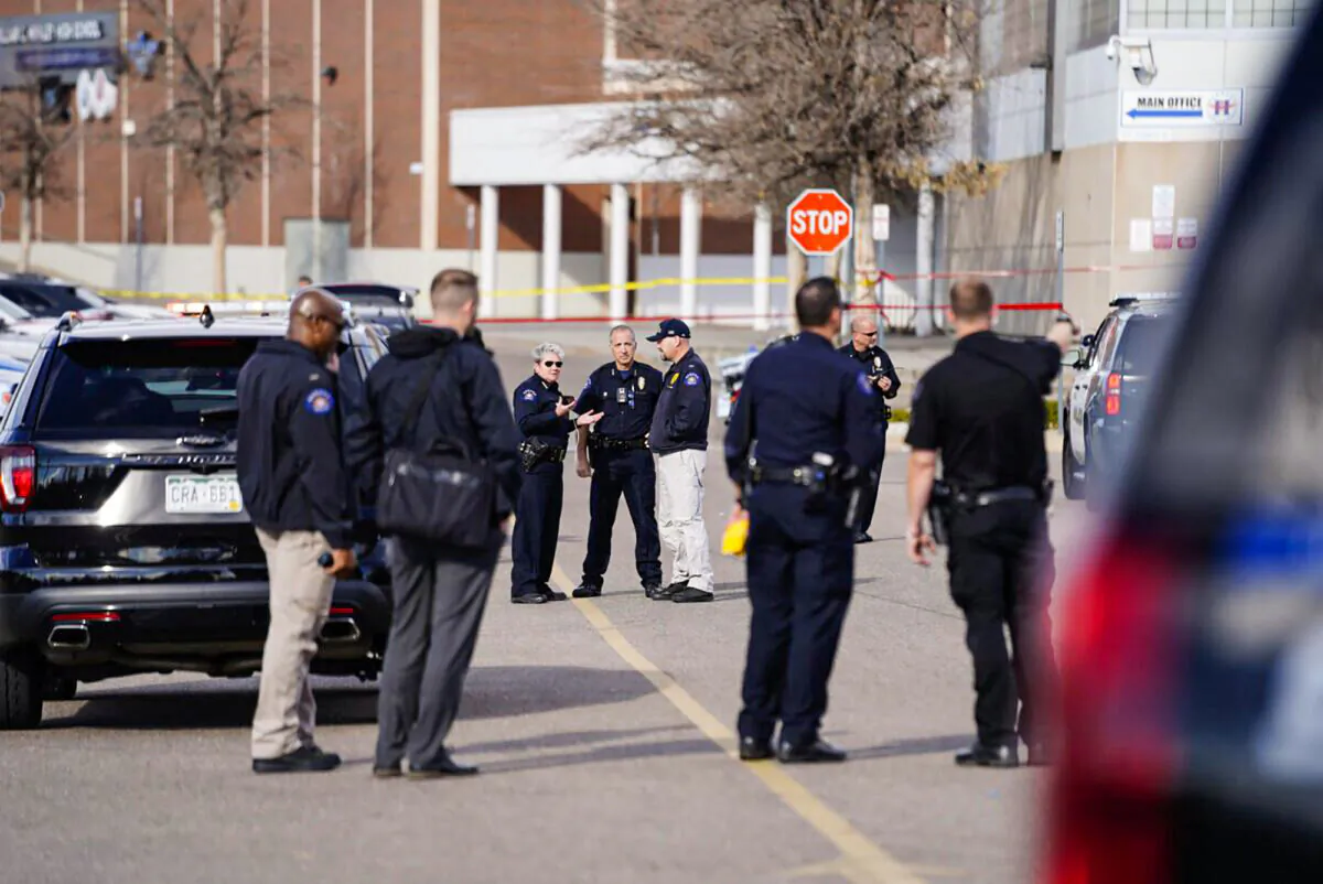 Law enforcement officers respond after a shooting in the parking lot of Hinkley High School in Aurora, Colo., on Nov. 19, 2021. (Philip B. Poston/Sentinel Colorado via AP)