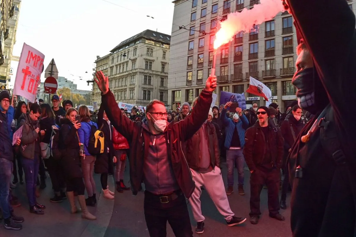 Demonstrators light flares during a rally held by Austria's Freedom Party against COVID-19 mandates in Vienna, Austria, on Nov. 20, 2021.  (Joe Klamar/AFP via Getty Images)