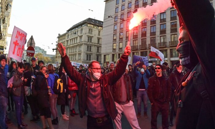 Demonstrators light flares during a rally held by Austria's Freedom Party against COVID-19 mandates in Vienna, Austria, on Nov. 20, 2021.  (Joe Klamar/AFP via Getty Images)
