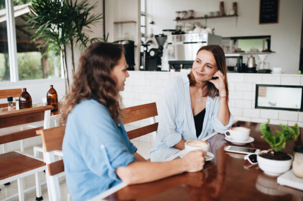 Cheerful,Female,Friends,Chatting,In,Cafe.,Two,Beautiful,Young,Women