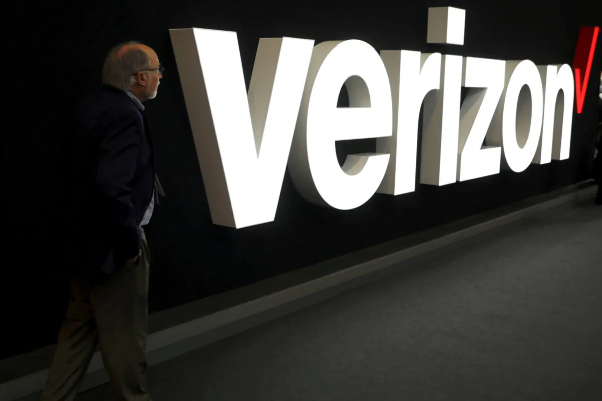 A man stands next to the logo of Verizon at the Mobile World Congress in Barcelona, Spain, on Feb. 26, 2019. (Sergio Perez/Reuters)