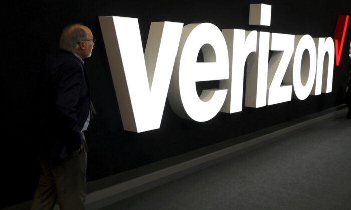 A man stands next to the logo of Verizon at the Mobile World Congress in Barcelona, Spain, on Feb. 26, 2019. (Sergio Perez/Reuters)