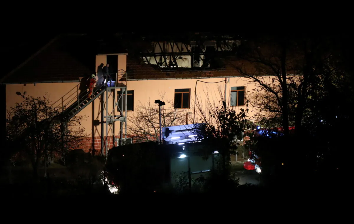 Firefighters enter a nursing home where nine people were killed in a fire in the village of Royak, Bulgaria, on Nov. 22, 2021. (Lyubomir Benkovski/Bulphoto Agency/via Reuters)