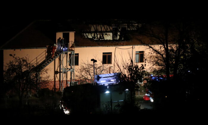 Firefighters enter a nursing home where nine people were killed in a fire in the village of Royak, Bulgaria, on Nov. 22, 2021. (Lyubomir Benkovski/Bulphoto Agency/via Reuters)
