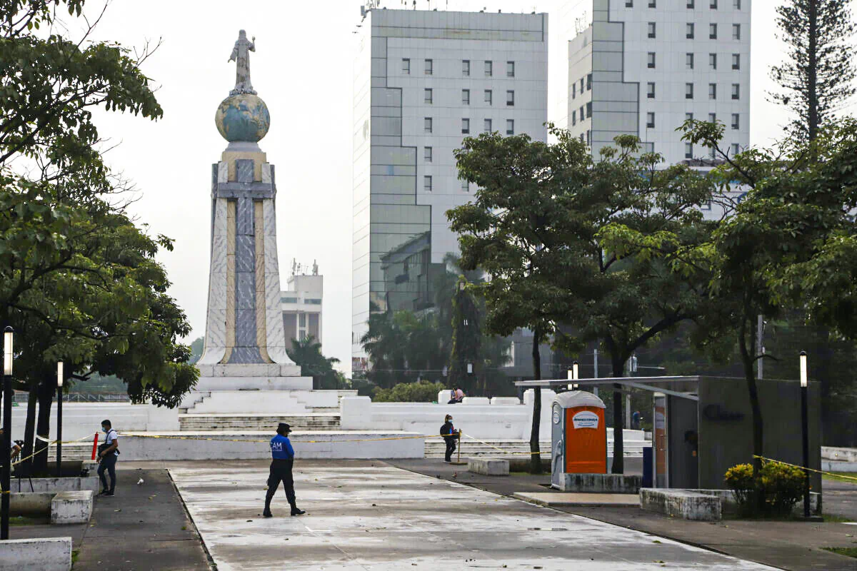 A police officer from the mayor's office patrols near the Chivo digital wallet machine, which will exchange cash for Bitcoin cryptocurrency, right, in Las Americas Square in San Salvador, El Salvador, on Sept. 7, 2021. (Salvador Melendez/AP Photo)
