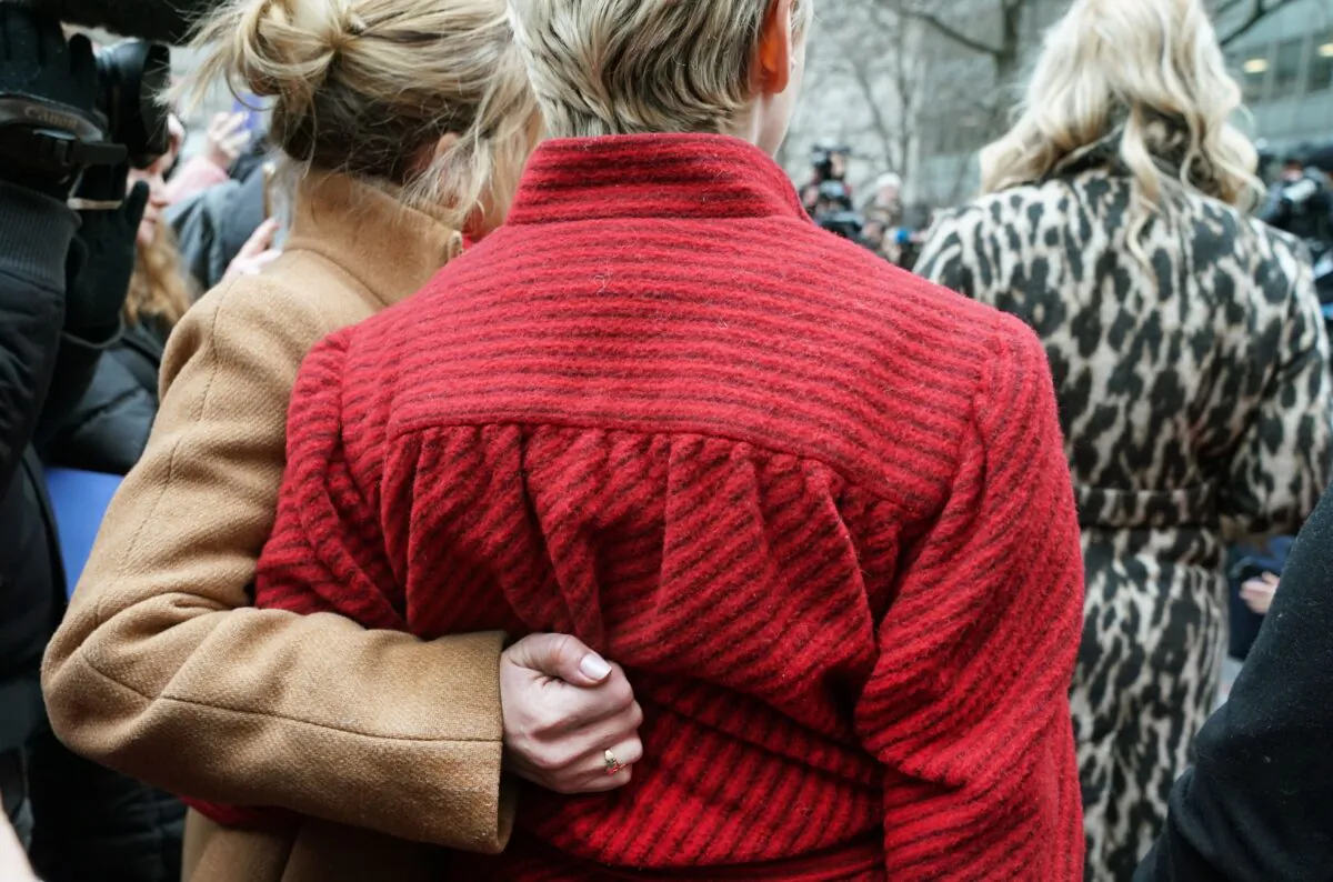 Actress Rose McCowen (in red) gathers with survivors of sexual abuse outside the courthouse after the arrival of Harvey Weinstein at the State Supreme Court in Manhattan, New York, on Jan. 6, 2020. (Timothy A. Clary/AFP via Getty Images)