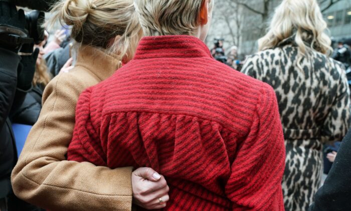 Actress Rose McCowen (in red) gathers with survivors of sexual abuse outside the courthouse after the arrival of Harvey Weinstein at the State Supreme Court in Manhattan, New York, on Jan. 6, 2020. (Timothy A. Clary/AFP via Getty Images)