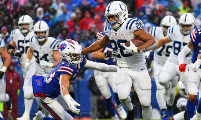 Indianapolis Colts running back Jonathan Taylor (28) stiff-arms Buffalo Bills safety Micah Hyde (23) on a run during the second half at Highmark Stadium in Orchard Park, N.Y., on Nov. 21, 2021. (Rich Barnes/USA TODAY Sports via Field Level Media)