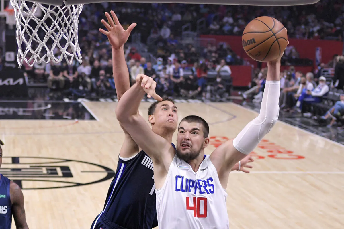 Los Angeles Clippers center Ivica Zubac, right, shoots as Dallas Mavericks center Dwight Powell defends during the first half of an NBA basketball game in Los Angeles on Nov. 21, 2021. (AP Photo/Mark J. Terrill)