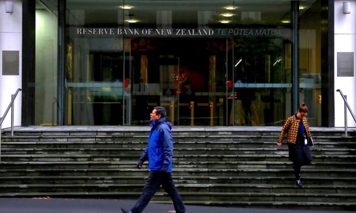 Pedestrians walk near the main entrance to the Reserve Bank of New Zealand located in central Wellington, New Zealand, on July 3, 2017. (David Gray/Reuters)