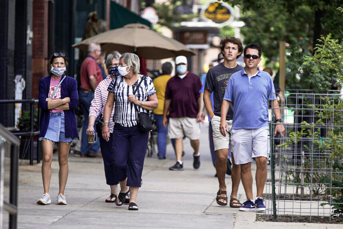 Pedestrians walk in downtown Omaha, Neb., on July 31, 2020. (AP Photo/Nati Harnik File)