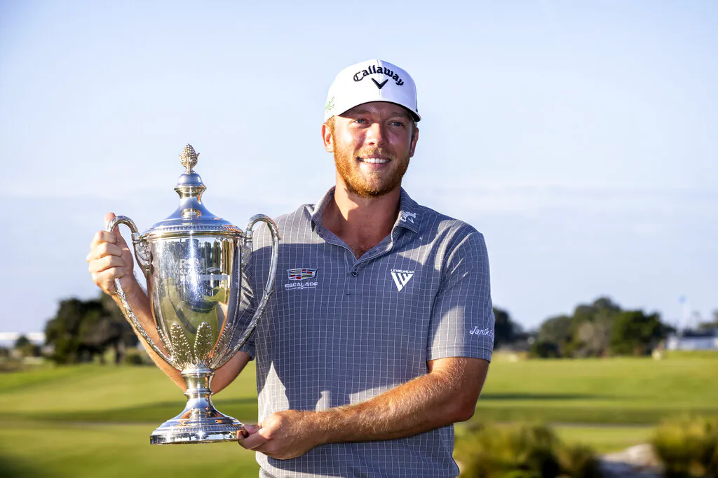 Talor Gooch holds the championship trophy after the final round of the RSM Classic golf tournament, in St. Simons Island, Ga, on Nov. 21, 2021. (Stephen B. Morton/AP Photo)